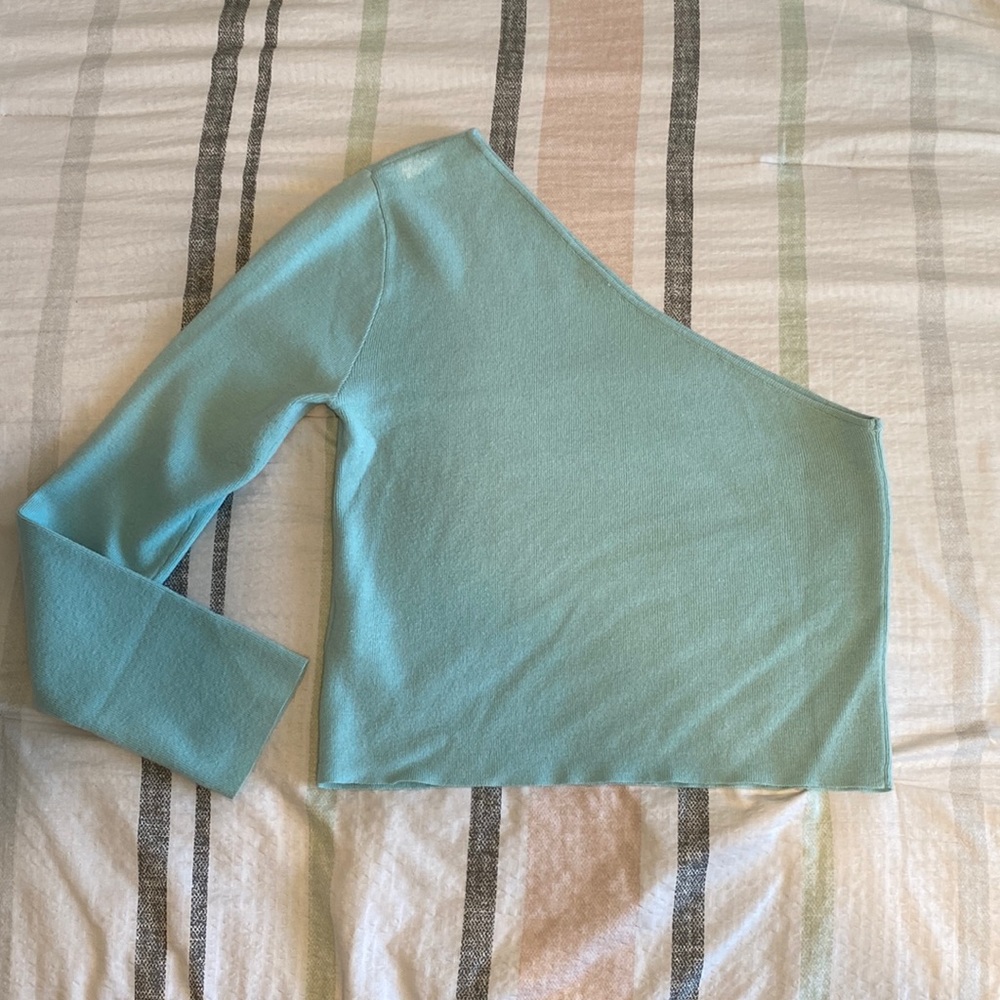 One sleeve light blue sweater